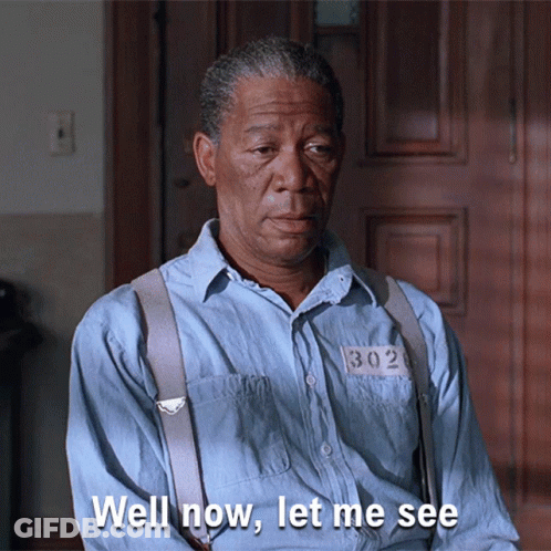 A Man In A Blue Shirt With Suspenders And A Number 302 On His Shirt Says Well Now Let Me See GIF