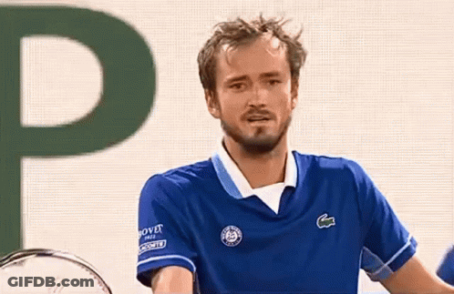 A Man In A Blue Shirt With The Letter P In The Background GIF
