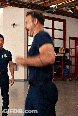 A Man In A Blue Shirt With The Letter S On His Chest GIF