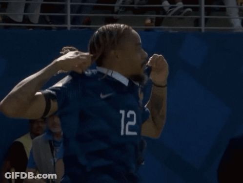 A Man In A Blue Shirt With The Number 12 On The Sleeve GIF