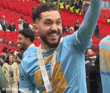 A Man In A Blue Shirt With The Number 20 On It GIF
