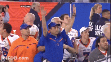 A Man In A Blue Shirt With The Word Florida On It Stands In A Crowd GIF