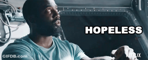 A Man In A Blue Shirt With The Word Hopeless Written Above Him GIF
