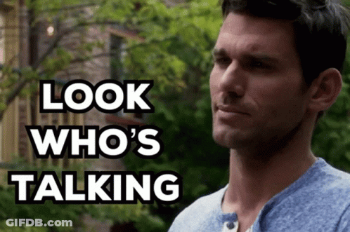 A Man In A Blue Shirt With The Words Look Who 'S Talking Behind Him GIF