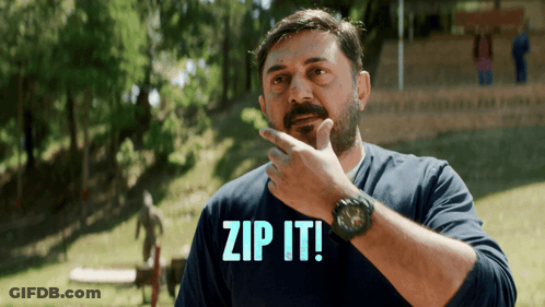 A Man In A Blue Shirt With The Words Zip It On It GIF