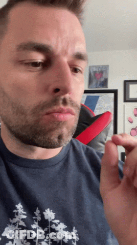 A Man In A Blue Shirt With Trees On It GIF