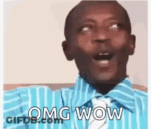A Man In A Blue Striped Shirt And Tie Is Making A Funny Face And Saying `` Omg Wow '' . GIF