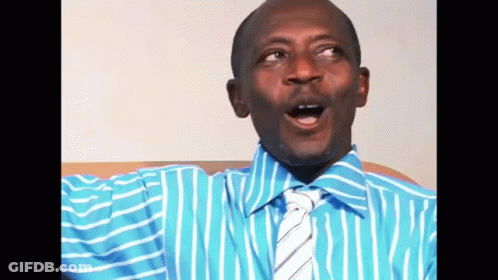 A Man In A Blue Striped Shirt And Tie Is Making A Funny Face GIF
