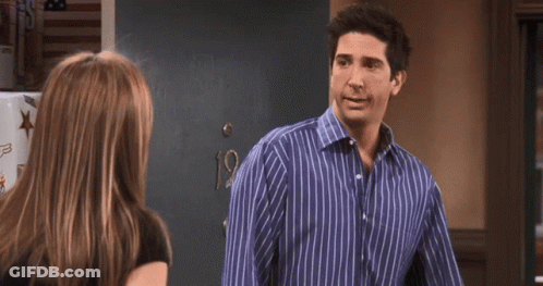 A Man In A Blue Striped Shirt Is Talking To A Woman In A Black Shirt And Says You Know What GIF