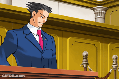 A Man In A Blue Suit And Pink Tie Is Standing At A Podium GIF