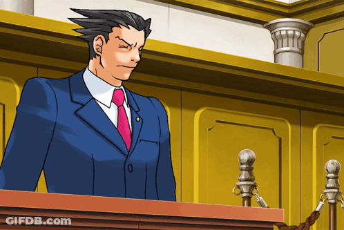 A Man In A Blue Suit And Pink Tie Stands At A Podium GIF