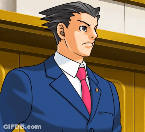 A Man In A Blue Suit And Pink Tie Stands In Front Of A Wall GIF