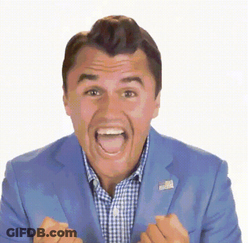 A Man In A Blue Suit And Plaid Shirt Is Making A Funny Face With His Mouth Open GIF