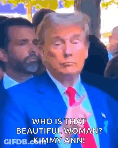 A Man In A Blue Suit And Red Tie Is Asking Who Is That Beautiful Woman Kimmy Ann GIF