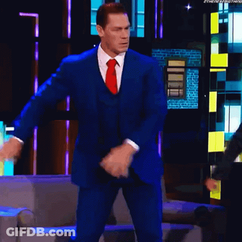 A Man In A Blue Suit And Red Tie Is Dancing On A Television Show . GIF