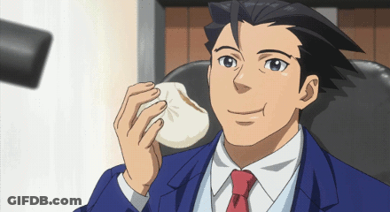 A Man In A Blue Suit And Red Tie Is Holding A Small White Object In His Hand GIF