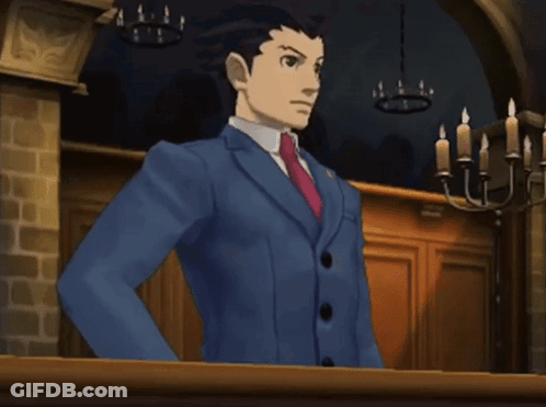 A Man In A Blue Suit And Red Tie Is Standing In Front Of A Chandelier GIF