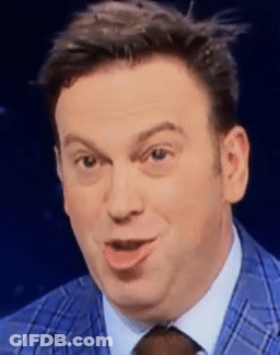 A Man In A Blue Suit And Tie Is Making A Face GIF