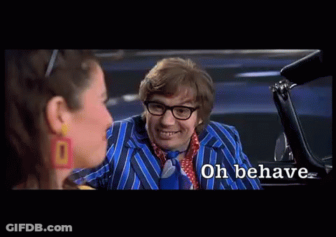 A Man In A Blue Suit And Tie Is Talking To A Woman In A Car And The Words Oh Behave Are Visible GIF
