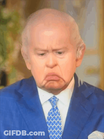 A Man In A Blue Suit And Tie Making A Sad Face GIF