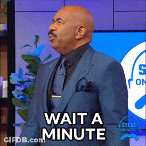 A Man In A Blue Suit And Tie Says Wait A Minute GIF