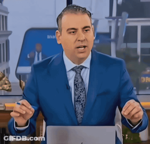 A Man In A Blue Suit And Tie Stands In Front Of A Screen That Says Dr. GIF