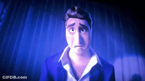 A Man In A Blue Suit And White Shirt Is Looking At The Camera GIF