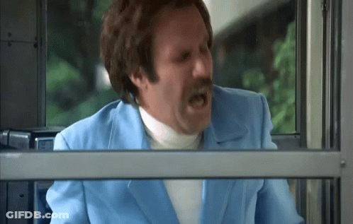 A Man In A Blue Suit And White Turtleneck Is Screaming While Looking Out Of A Window . GIF