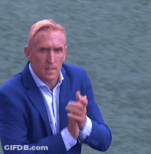 A Man In A Blue Suit Giving A Thumbs Up Sign GIF