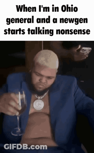 A Man In A Blue Suit Holds A Glass Of Wine GIF