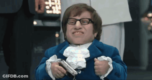 A Man In A Blue Suit Holds A Gun GIF