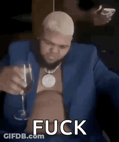 A Man In A Blue Suit Is Holding A Glass Of Wine And Smoking A Cigarette . GIF