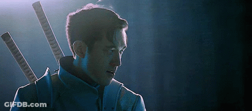 A Man In A Blue Suit Is Holding Two Swords In His Back . GIF