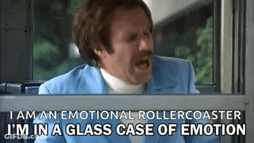 A Man In A Blue Suit Is Looking Out Of A Window And Says I Am An Emotional Rollercoaster . GIF