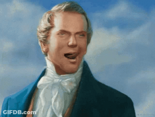 A Man In A Blue Suit Is Making A Face With His Mouth Open GIF