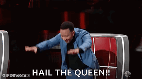 A Man In A Blue Suit Is Sitting In A Chair With His Arms Outstretched . GIF