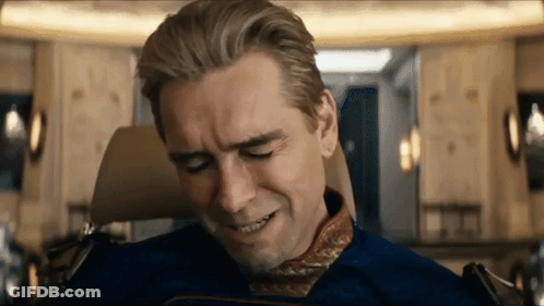 A Man In A Blue Suit Is Sitting In A Chair With His Eyes Closed And His Mouth Open . GIF