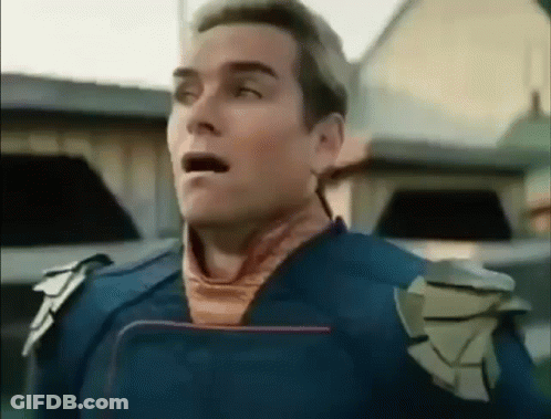 A Man In A Blue Suit Is Standing In Front Of A Building With His Mouth Open And His Eyes Closed . GIF