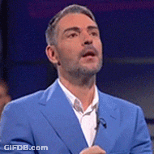 Man In Blue Suit Standing At Microphone GIF