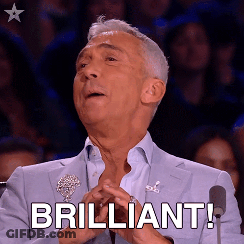 A Man In A Blue Suit Says Brilliant In Front Of A Microphone GIF