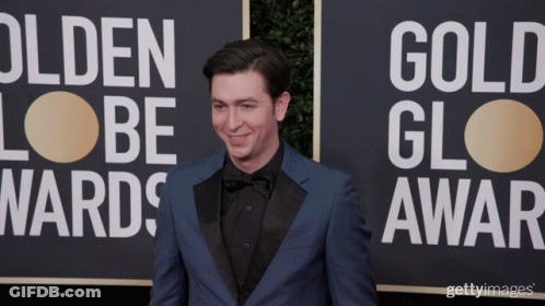 A Man In A Blue Suit Stands In Front Of A Sign That Says Olden Lobe Wards GIF
