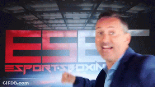 A Man In A Blue Suit Stands In Front Of A Sports Boxing Sign GIF