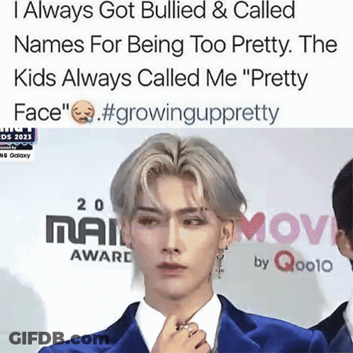 A Man In A Blue Suit Stands On A Red Carpet With A Caption That Says I Always Got Bullied GIF