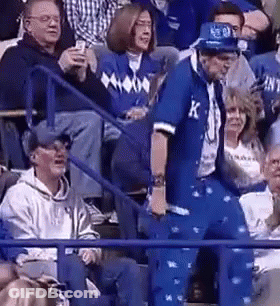 A Man In A Blue Suit With The Letter K On It GIF