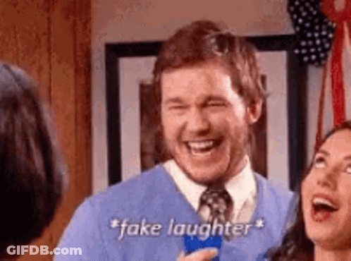 A Man In A Blue Sweater And Tie Is Laughing In Front Of A Woman . GIF