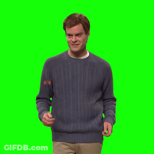 A Man In A Blue Sweater Holds His Hands Up In The Air GIF