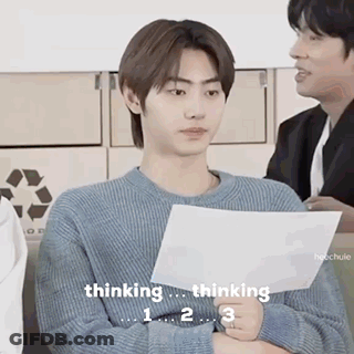 A Man In A Blue Sweater Is Holding A Piece Of Paper And Thinking . GIF