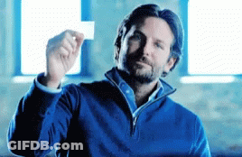A Man In A Blue Sweater Is Holding Up A White Card GIF