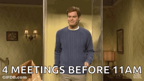 A Man In A Blue Sweater Is Standing In A Room With The Words " 4 Meetings Before 11Am " Written On The Bottom GIF