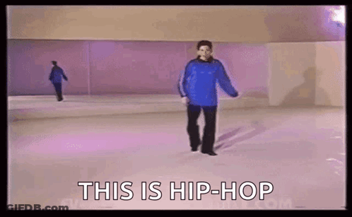 A Man In A Blue Sweater Is Walking On A Purple Ice Rink . GIF